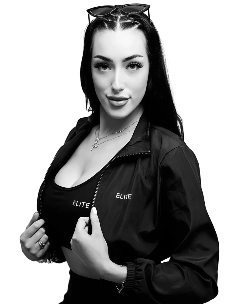 Black and white photo of a woman wearing an 'Elite' jacket with ENVOLE branding.