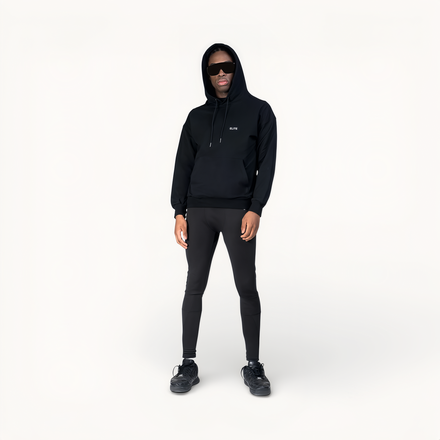Man wearing a black hoodie with ‘Elite’ logo in front of a white background.