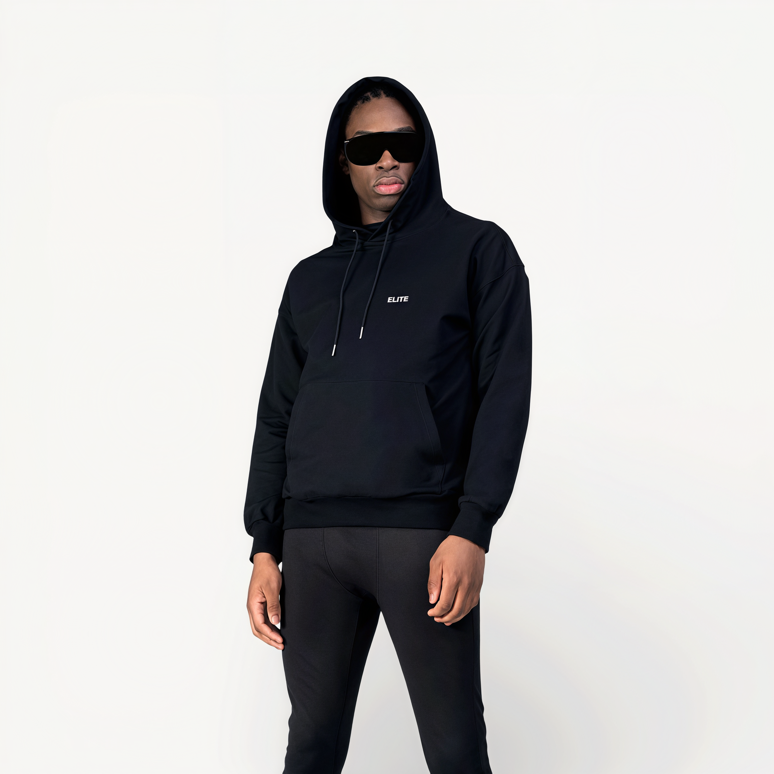 Man wearing a black athletic hoodie with ‘Elite logo in front of a white background.