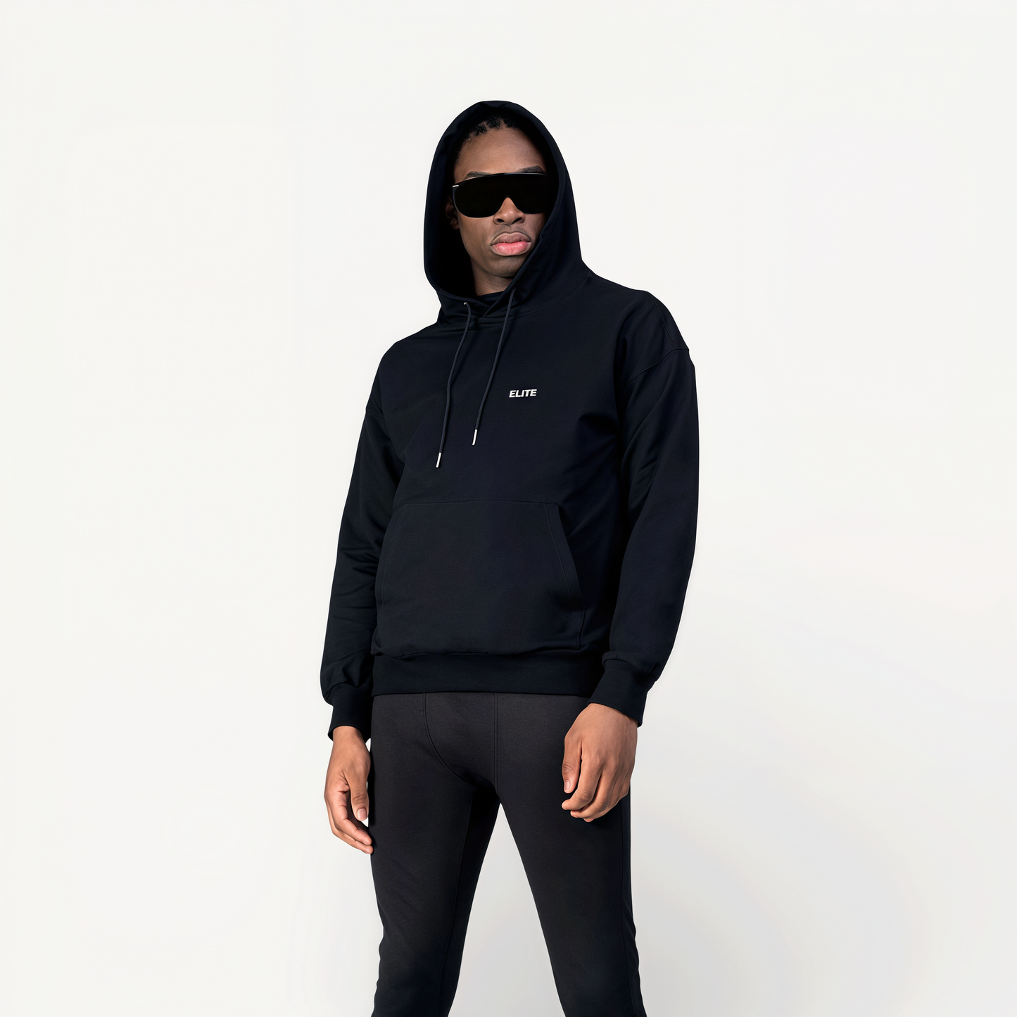 Man wearing a black athletic hoodie with ‘Elite logo in front of a white background.