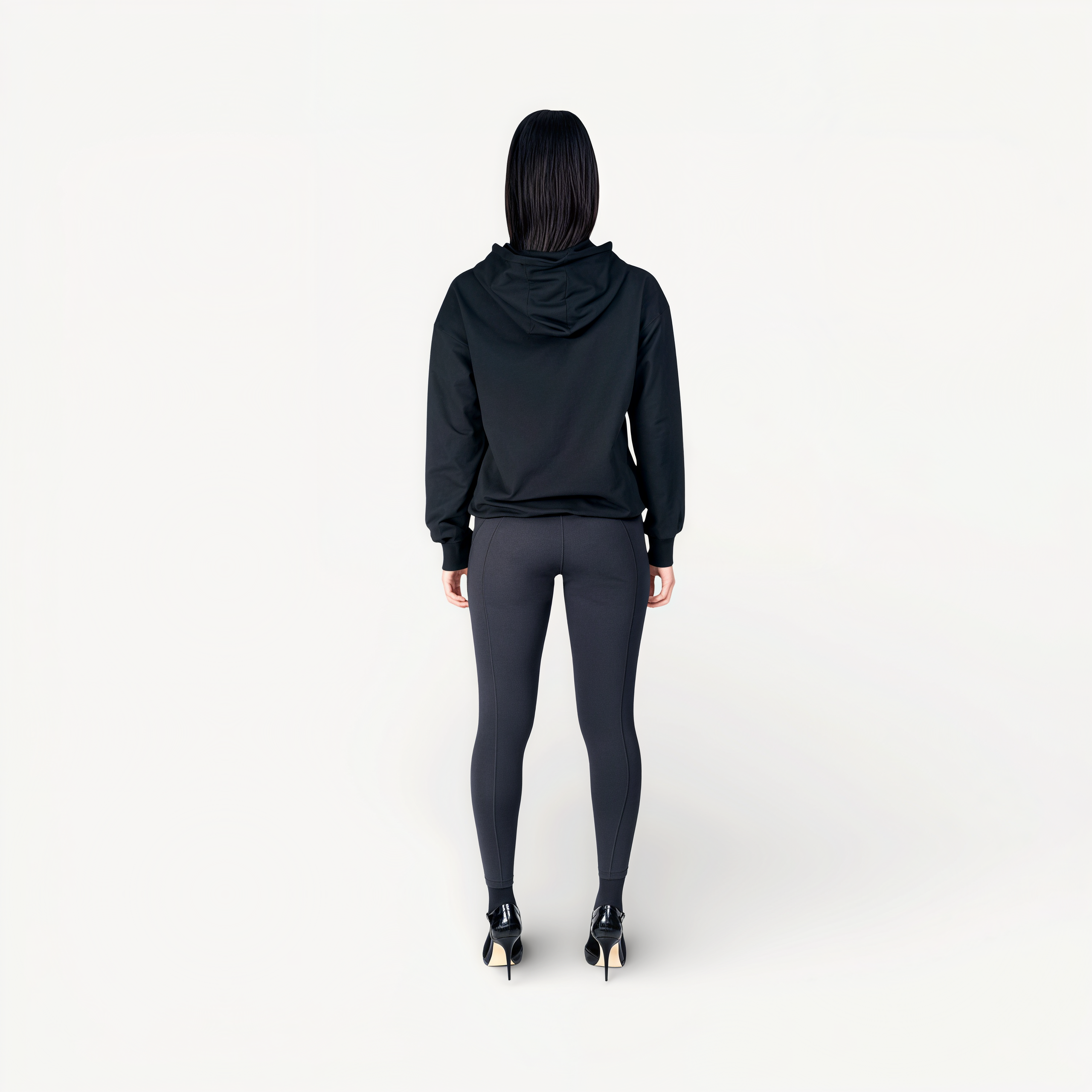 Woman wearing a black hoodie and leggings with ‘Elite’ ENVOLE logo back view.