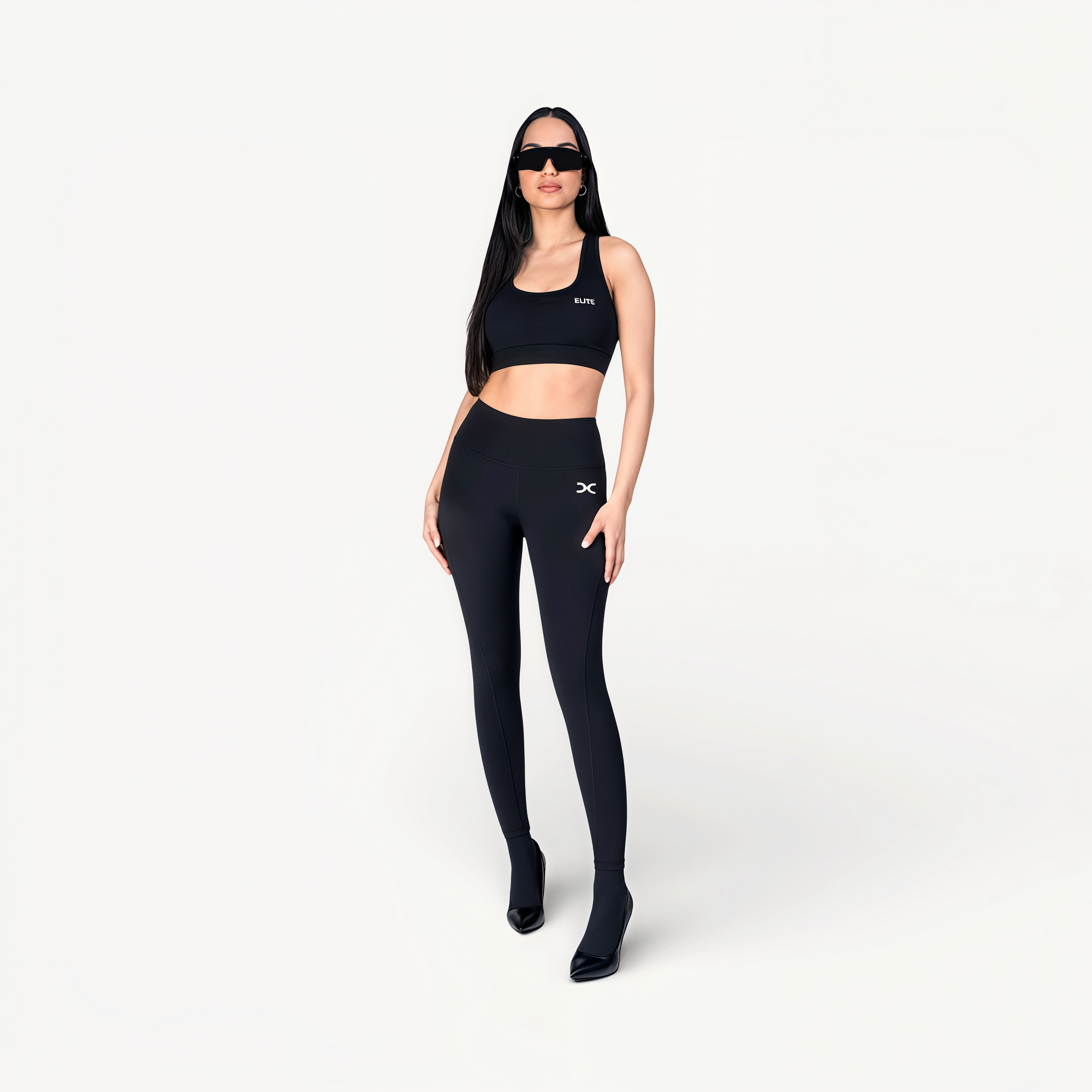 Woman wearing a black athletic outfit with ‘Elite’ ENVOLE branding front view.