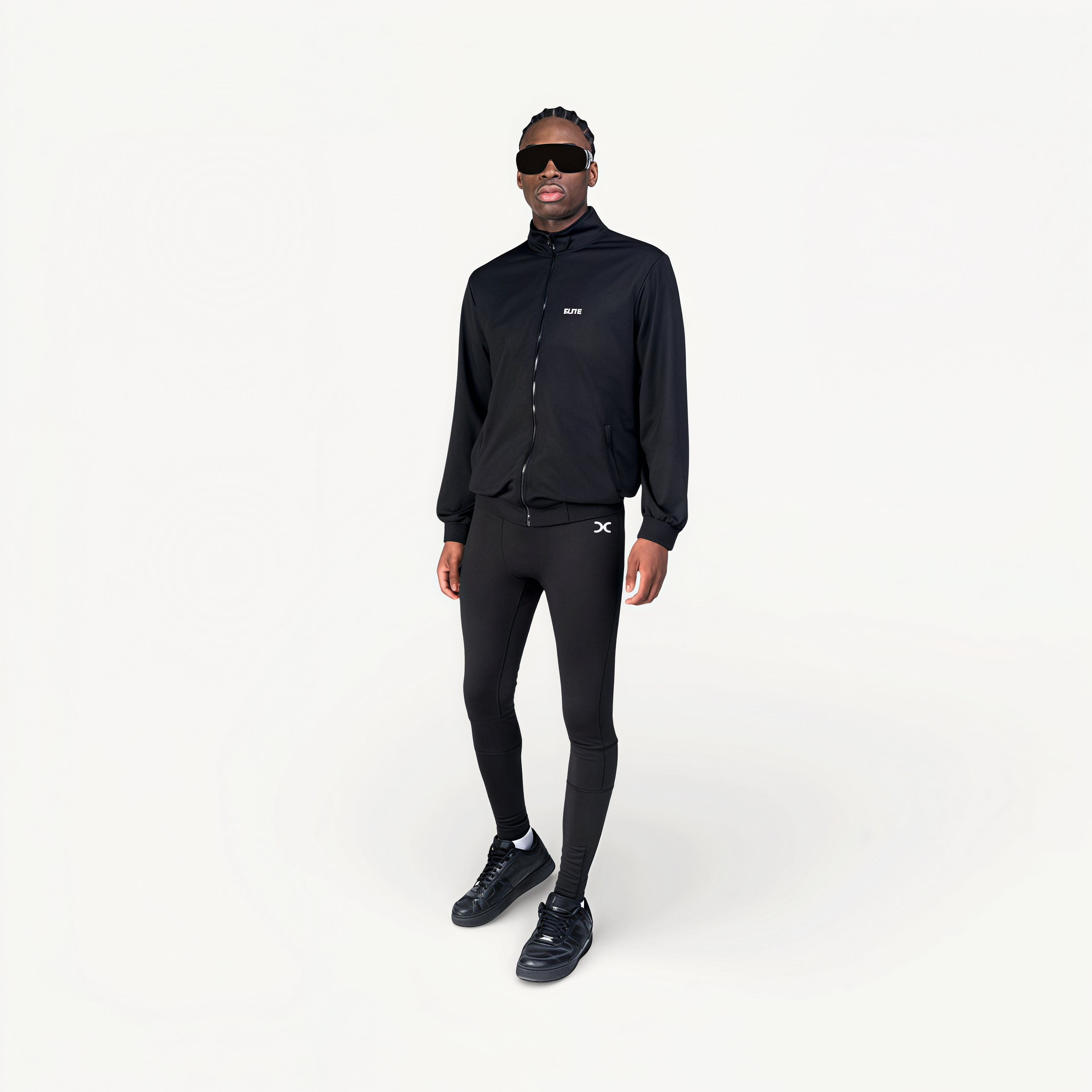 Man wearing a black tracksuit with ‘Elite’ ENVOLE branding.