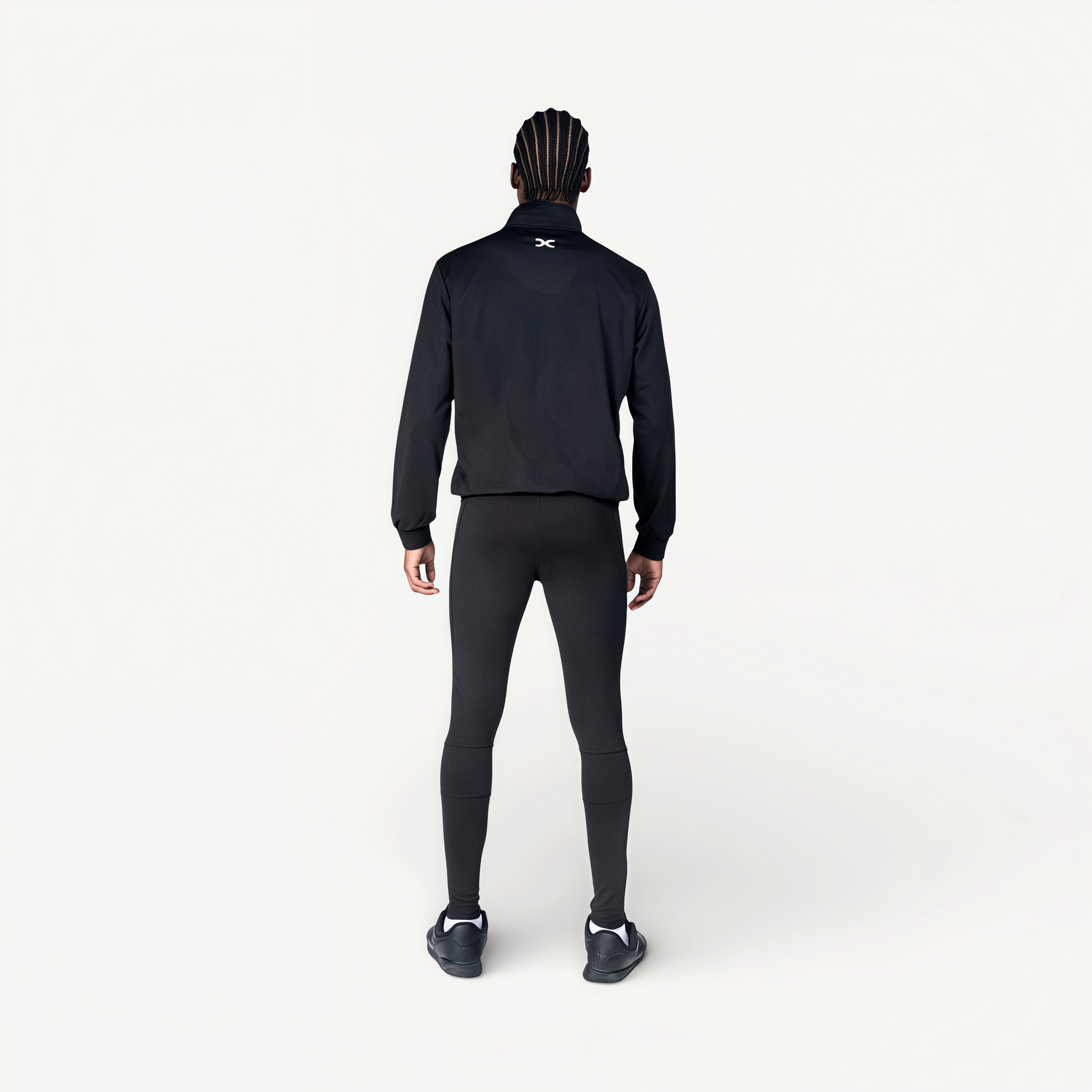 Man wearing a black tracksuit with ‘Elite’ ENVOLE branding.