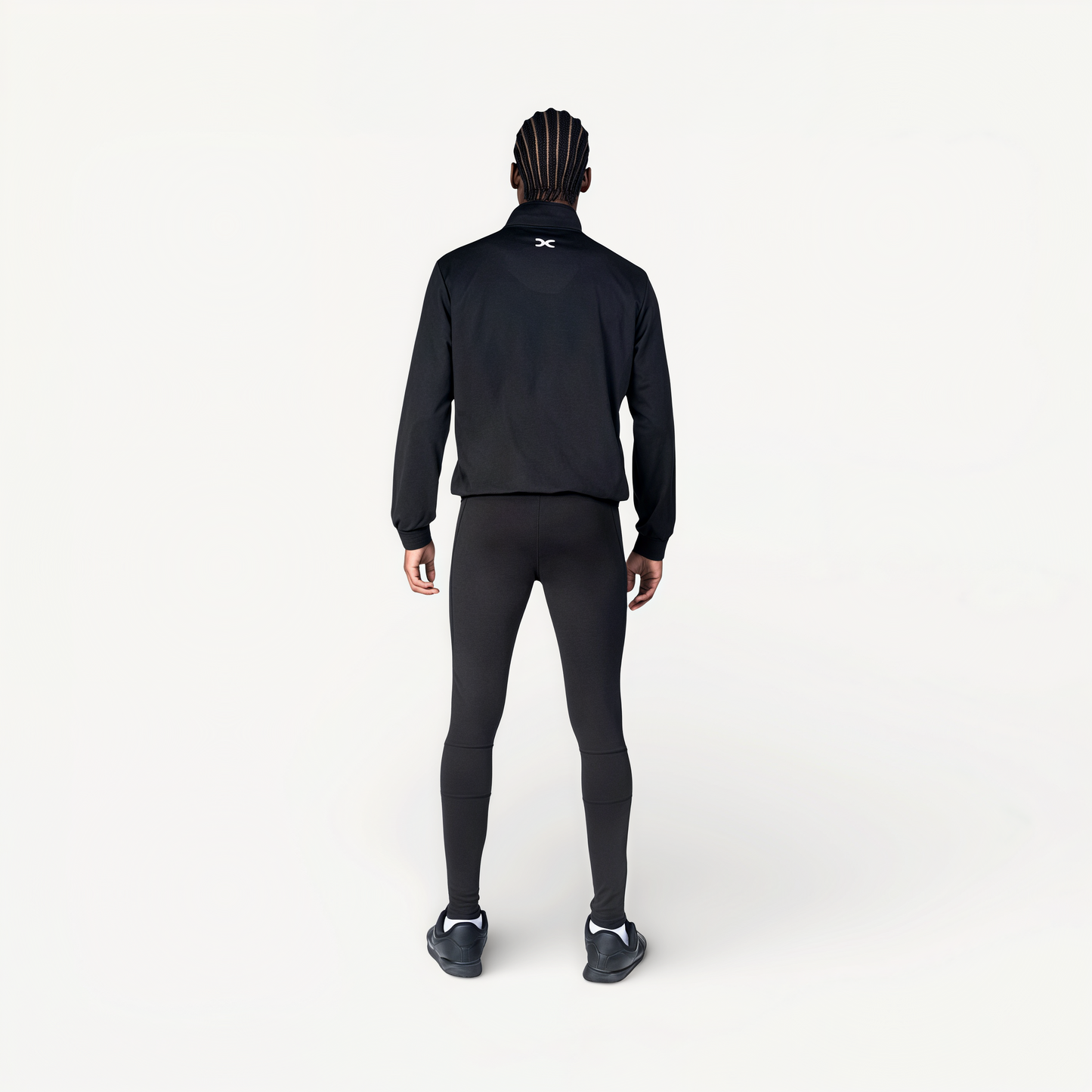 Man wearing a black tracksuit with ‘Elite’ ENVOLE branding.