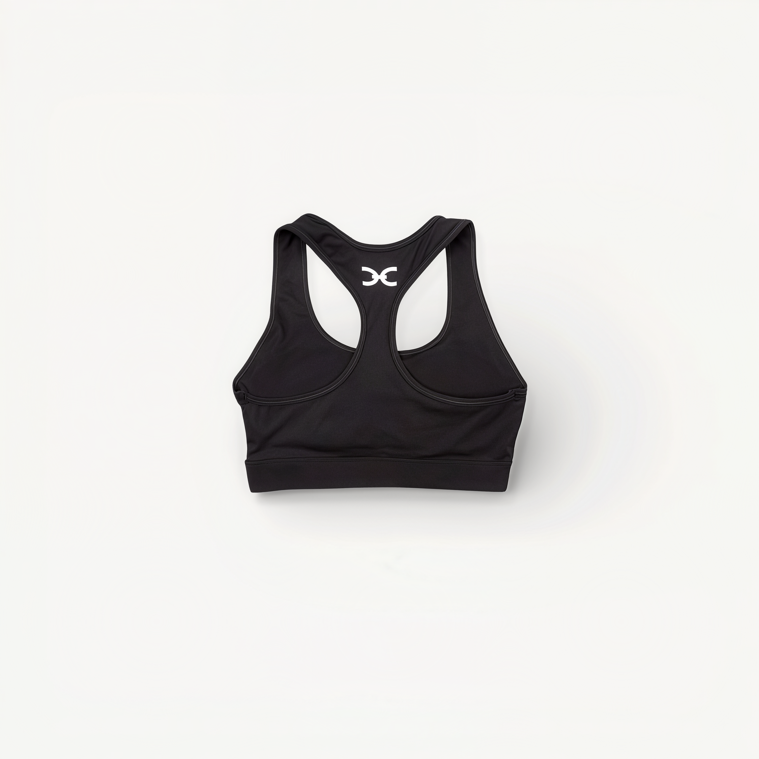 Black sports bra with 'Elite' ENVOLE branding on a white background back view.