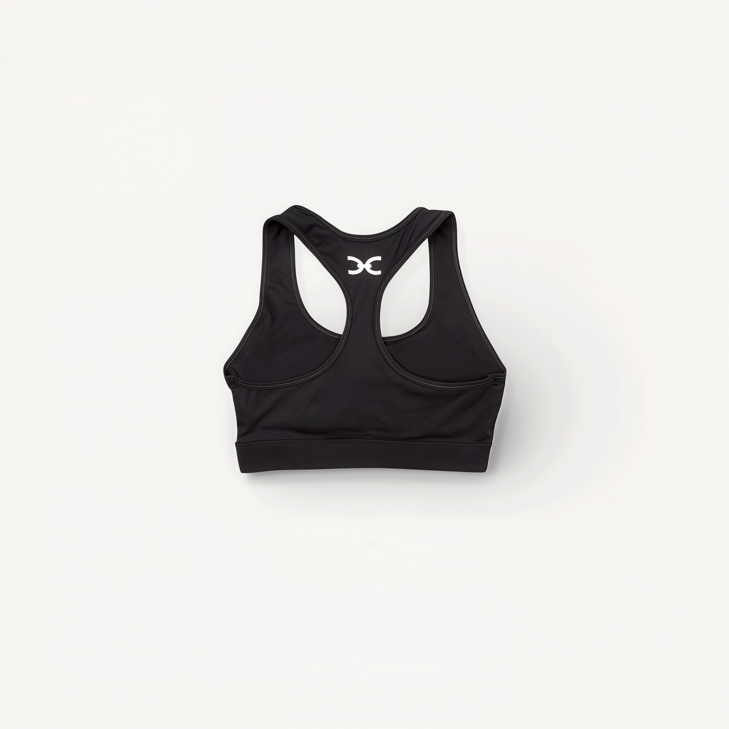 Black sports bra with 'Elite' ENVOLE branding on a white background back view.