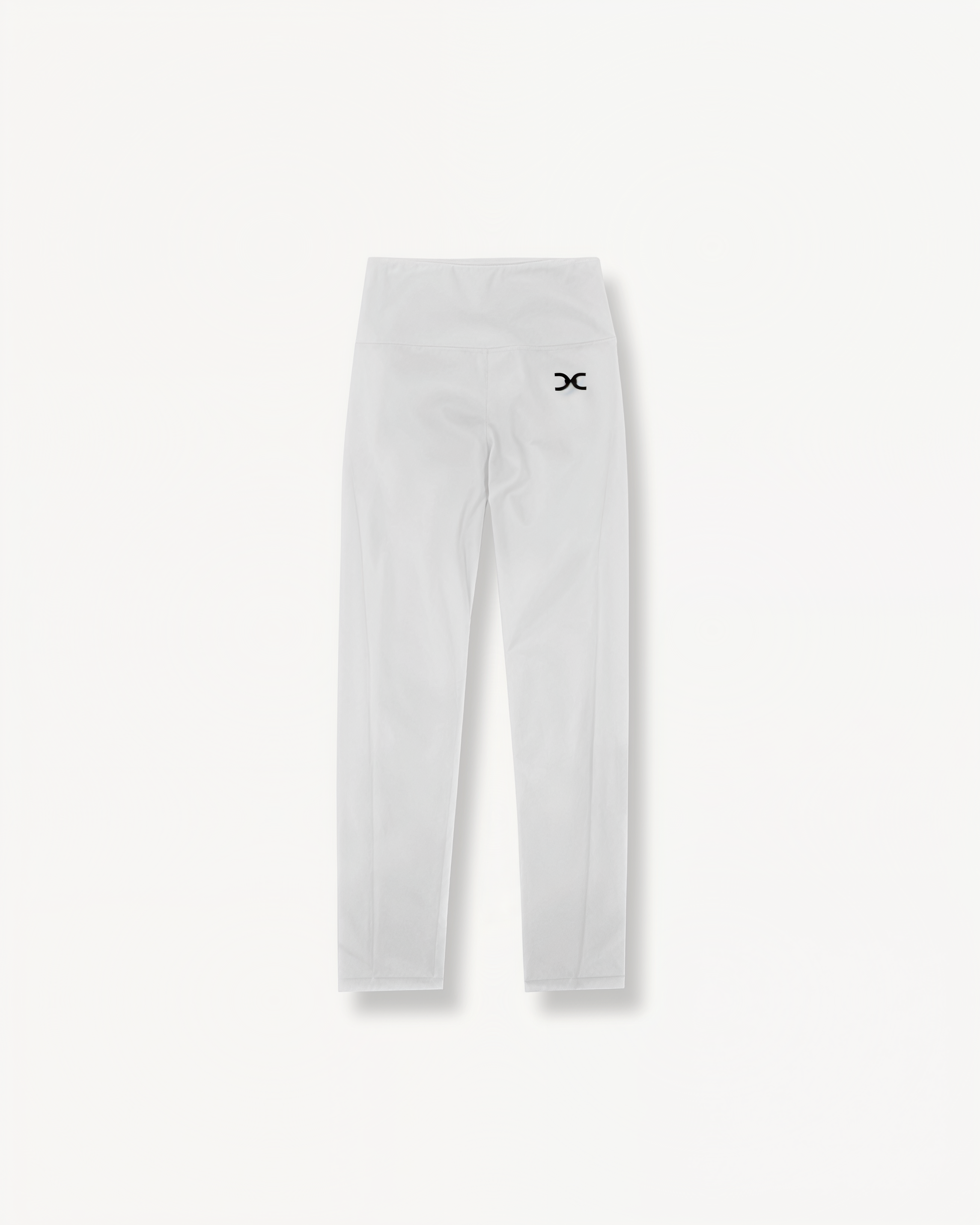 White leggings with a black ENVOLE logo on a light gray background front view.