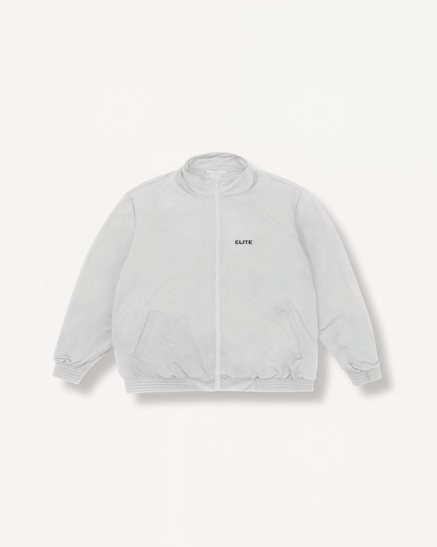 White jacket with ‘Elite’ ENVOLE logo on a light gray background front view.