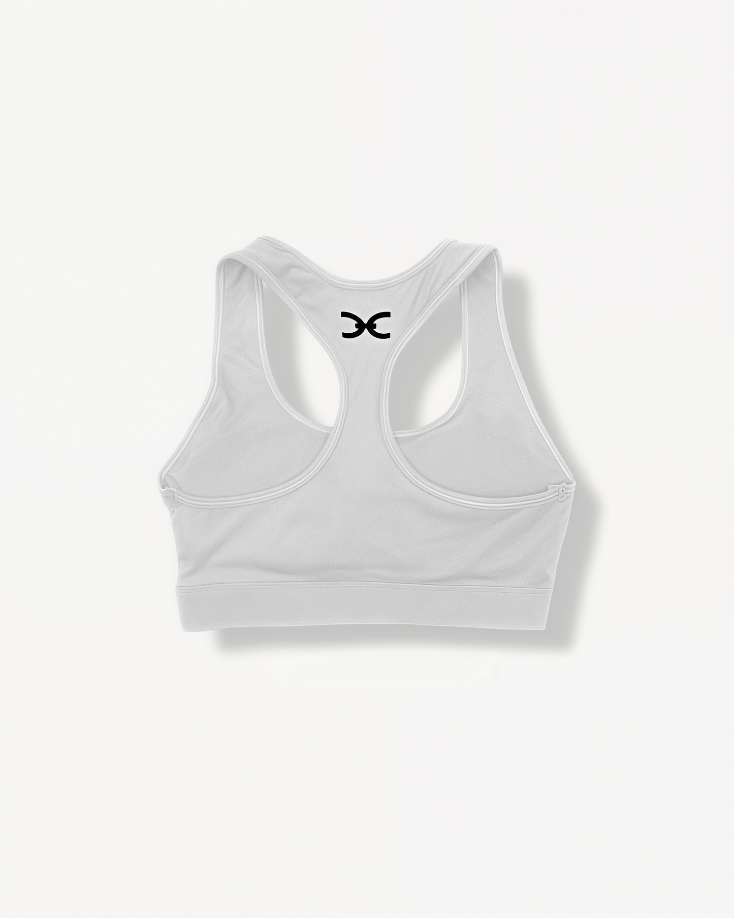 White sports bra with 'ELITE' ENVOLE logo on a white background back view.